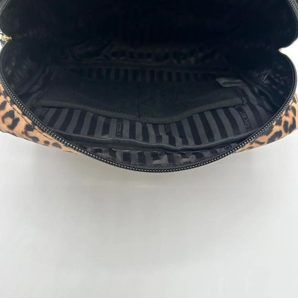 Victoria's Secret Leopard print makeup bag with black stripes interior.